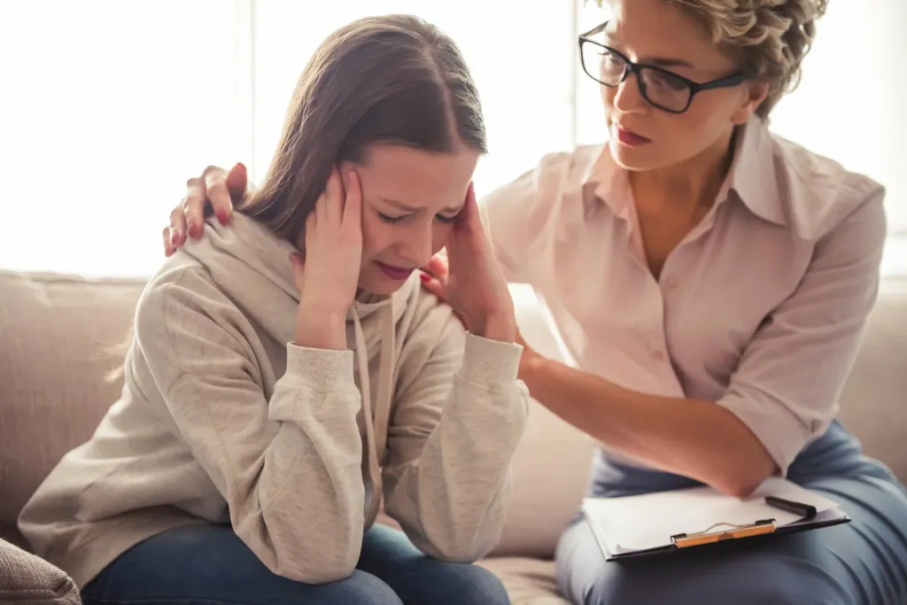 Practitioner comforting a client during a personal consultation